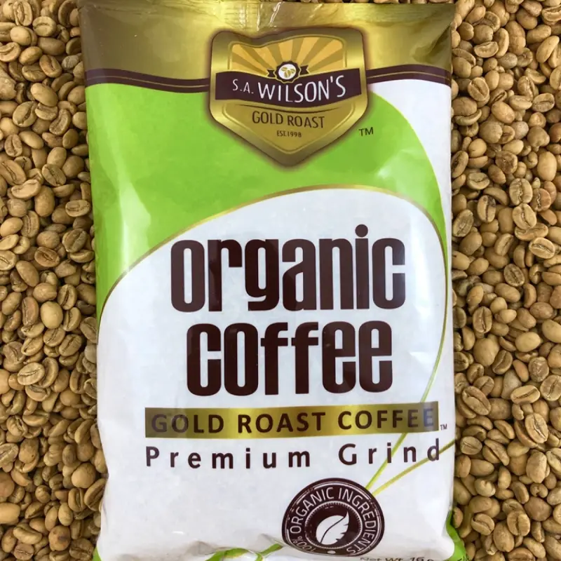 S.A. Wilson’s Gold Roast Bag on top of light roasted beans